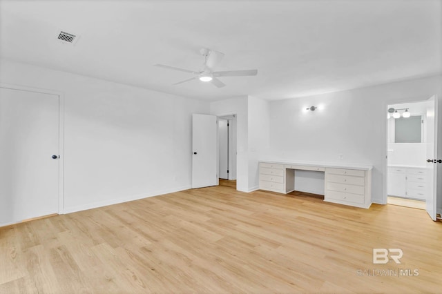 18 Rollins Pl, Atmore, AL 36502 - unfurnished living room featuring ceiling fan, built in study area, and light wood finished floors
