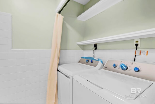18 Rollins Pl, Atmore, AL 36502 - washroom featuring washing machine and dryer, tile walls, and wainscoting