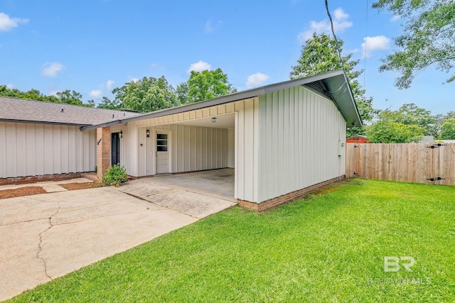 18 Rollins Pl, Atmore, AL 36502 - view of front of home featuring driveway, a carport, and roof with shingles