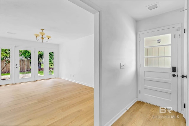 18 Rollins Pl, Atmore, AL 36502 - foyer featuring light wood-style flooring and a chandelier