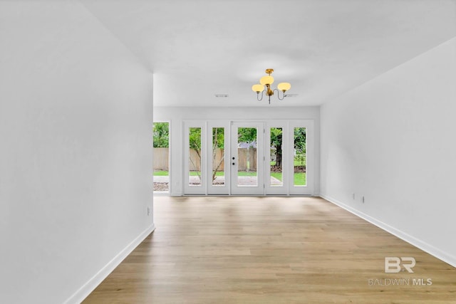 18 Rollins Pl, Atmore, AL 36502 - unfurnished living room with a chandelier and light wood-type flooring