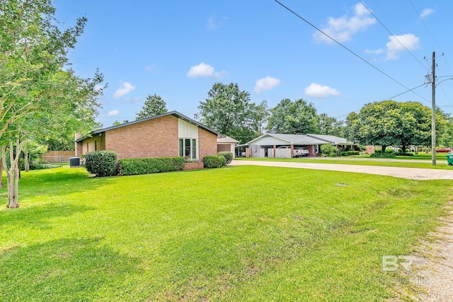 18 Rollins Pl, Atmore, AL 36502 - mid-century inspired home with concrete driveway, brick siding, and a front yard