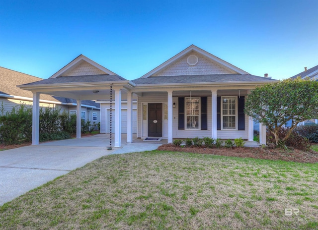 view of front facade with covered porch, a carport, a front yard, and a garage