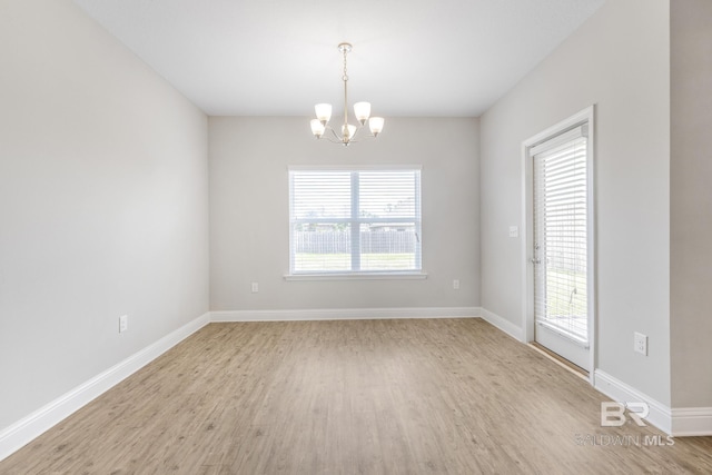 31689 Kestrel Loop, Spanish Fort, AL 36527 - unfurnished room with a chandelier, light wood-style floors, and baseboards