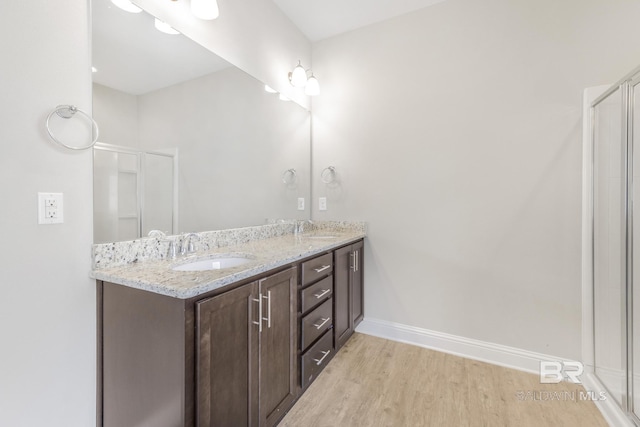 31689 Kestrel Loop, Spanish Fort, AL 36527 - bathroom with baseboards, wood finished floors, double vanity, and a shower stall