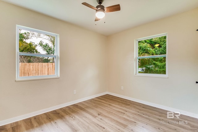 empty room with ceiling fan and light wood-type flooring