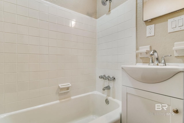 bathroom with vanity and tiled shower / bath combo