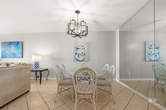 dining space with light tile patterned floors, baseboards, and an inviting chandelier