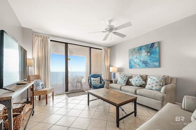 living area with light tile patterned floors and ceiling fan