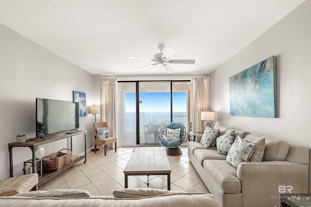 living area with ceiling fan and tile patterned floors