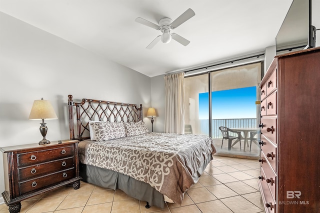 bedroom featuring access to exterior, light tile patterned flooring, and ceiling fan