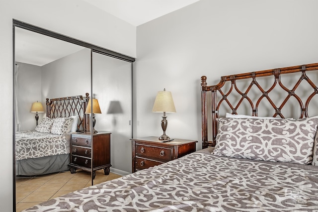 bedroom with a closet and tile patterned floors