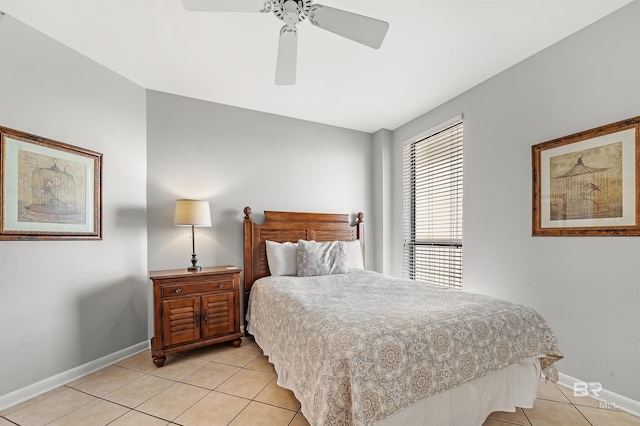 bedroom with a ceiling fan, baseboards, and light tile patterned floors