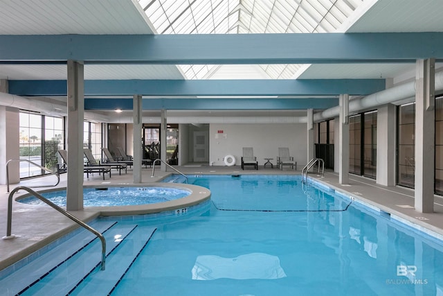 community pool with an indoor hot tub and a patio