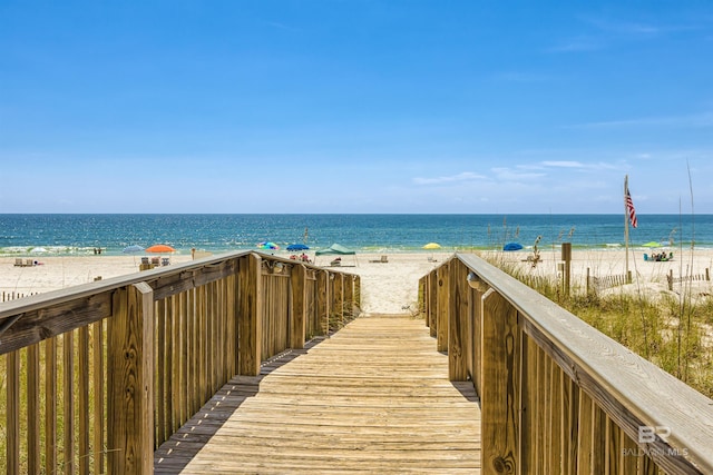 view of property's community with a water view and a view of the beach