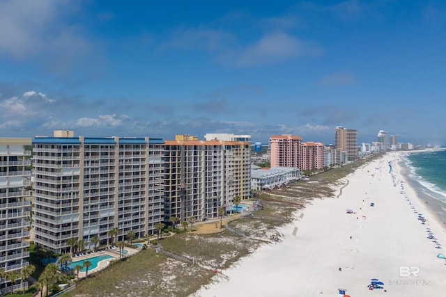 birds eye view of property with a view of city, a beach view, and a water view