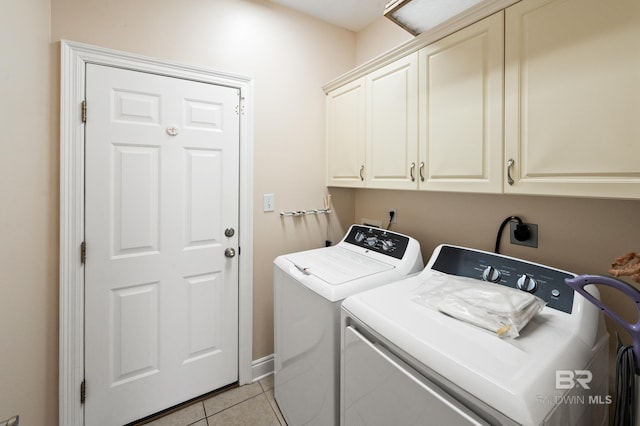 laundry room featuring light tile patterned floors, cabinets, and independent washer and dryer