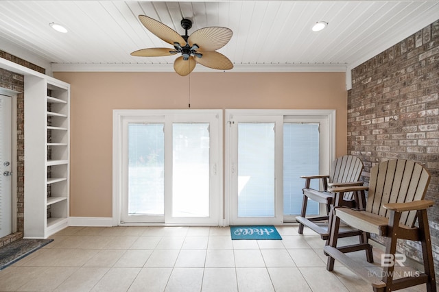 interior space featuring brick wall, light tile patterned flooring, wooden ceiling, and ceiling fan