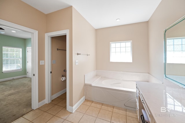 bathroom with vanity, a bathing tub, and tile patterned floors