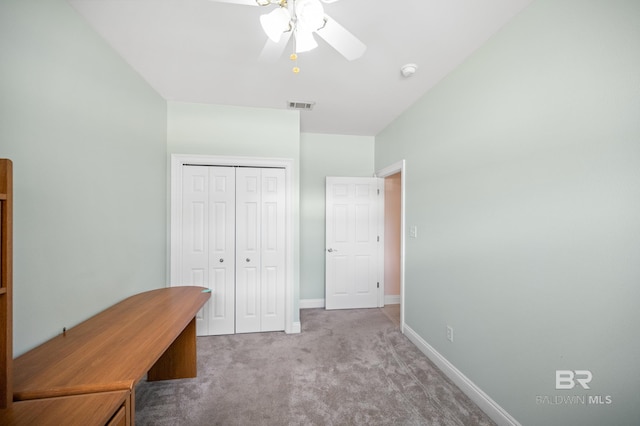 unfurnished office featuring ceiling fan and light colored carpet