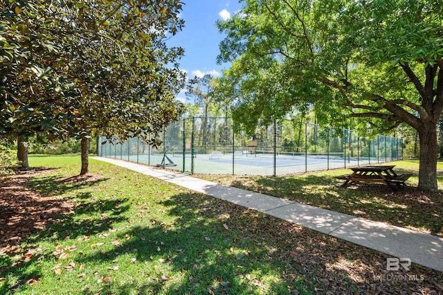 view of sport court with a yard