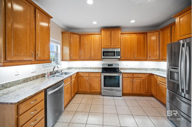 kitchen with light stone counters, light tile patterned floors, ornamental molding, sink, and appliances with stainless steel finishes