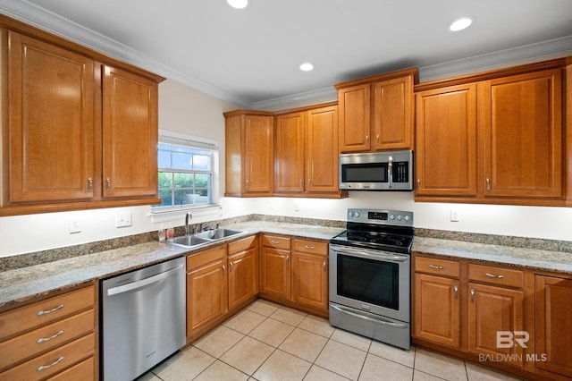 kitchen with ornamental molding, light tile patterned flooring, appliances with stainless steel finishes, and sink