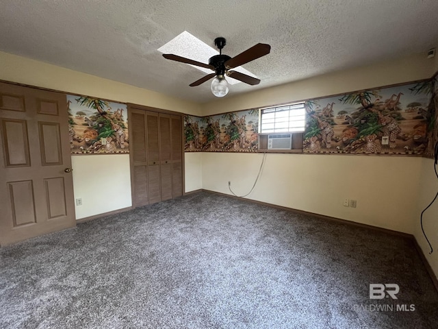 unfurnished room featuring cooling unit, ceiling fan, carpet, and a textured ceiling