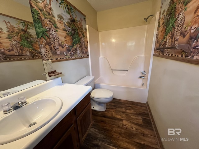 full bathroom featuring wood-type flooring, vanity, shower / bathtub combination, and toilet