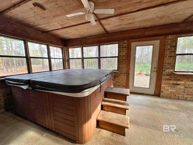 unfurnished sunroom featuring a hot tub and wooden ceiling