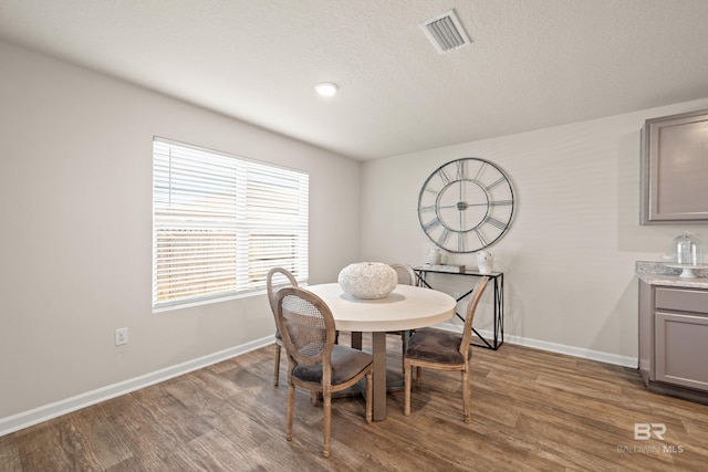 dining space with hardwood / wood-style floors