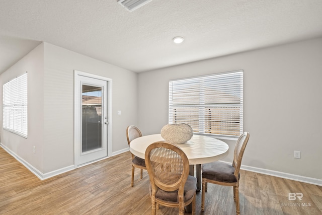 dining space featuring light wood-type flooring