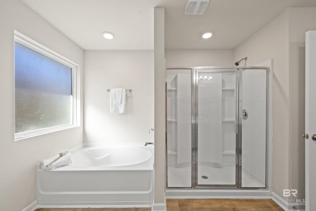 bathroom featuring shower with separate bathtub