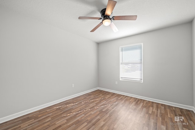 spare room featuring dark hardwood / wood-style floors and ceiling fan