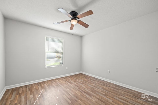 spare room featuring ceiling fan and wood-type flooring