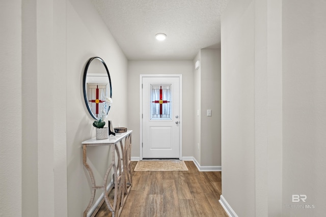 entryway featuring hardwood / wood-style floors and a textured ceiling