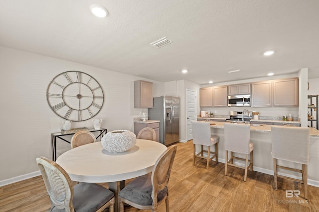 dining room with light wood-type flooring