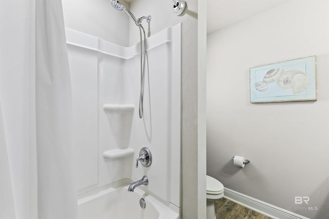 bathroom featuring toilet, shower / bath combination, and wood-type flooring