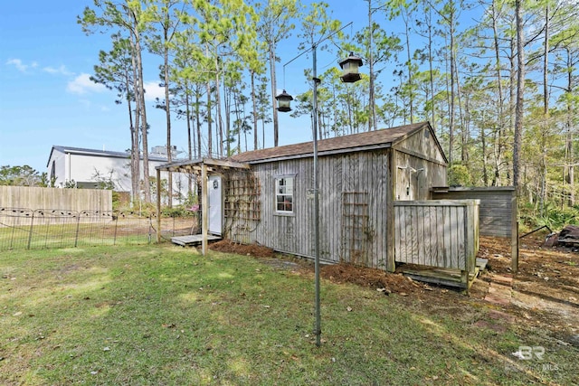 view of outbuilding featuring a yard