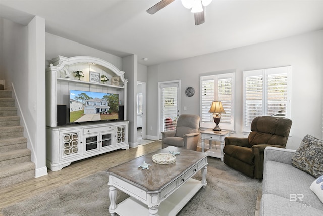 living room featuring ceiling fan and hardwood / wood-style flooring