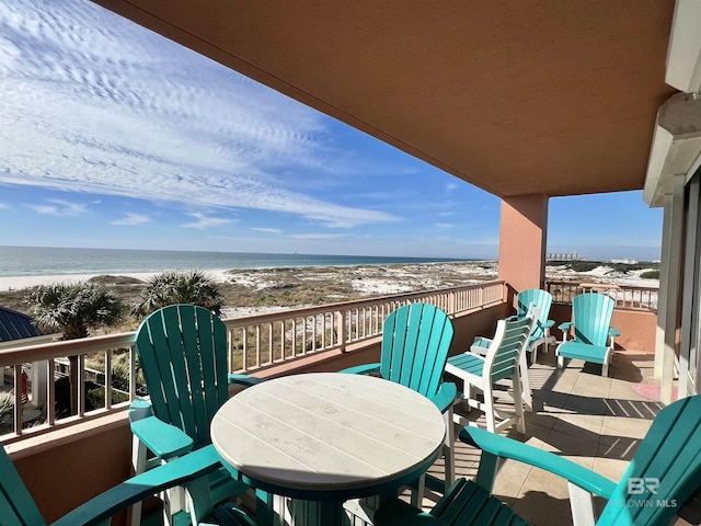 balcony with a water view and a beach view