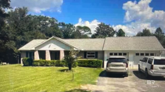 single story home with a garage and a front yard