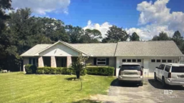 10398 Route Rd, Lillian, AL 36549 - ranch-style home with concrete driveway, a front yard, and an attached garage