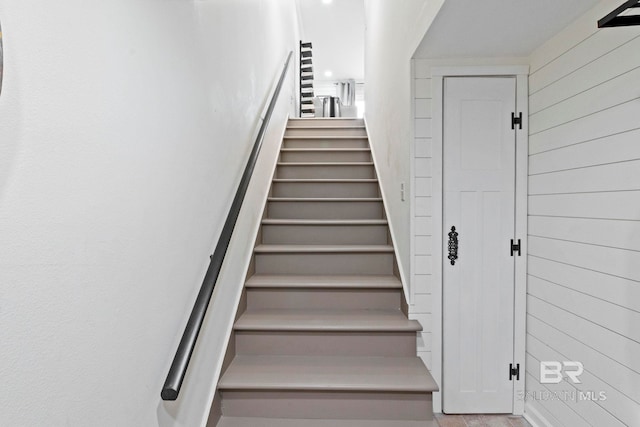 staircase with wooden walls