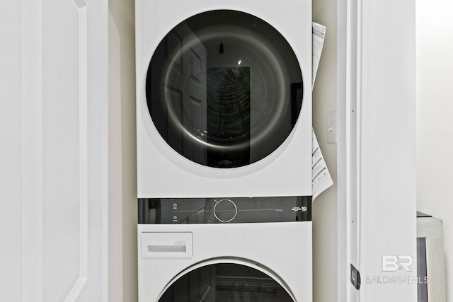 laundry area featuring stacked washer / drying machine