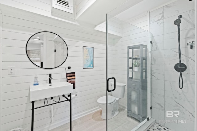 bathroom with sink, a shower with door, wood-type flooring, and toilet