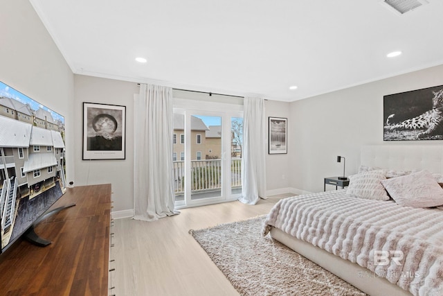 bedroom with ornamental molding, light hardwood / wood-style flooring, and access to exterior