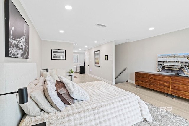 bedroom with light wood-type flooring and ornamental molding