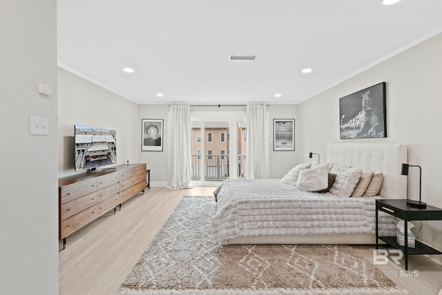 bedroom featuring crown molding, light hardwood / wood-style flooring, and access to exterior