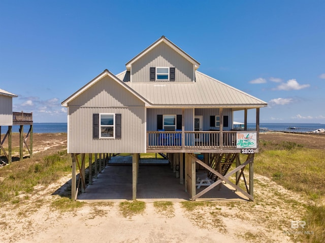 2802 Bienville Blvd, Dauphin Island, AL 36528 - view of front of home with metal roof, a water view, driveway, and a carport